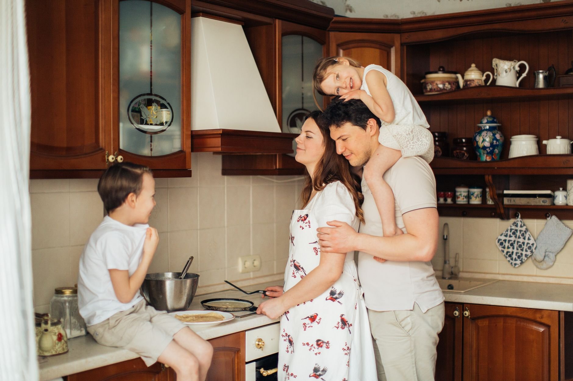 A joyful family moment as parents and children cook together in a cozy kitchen setting